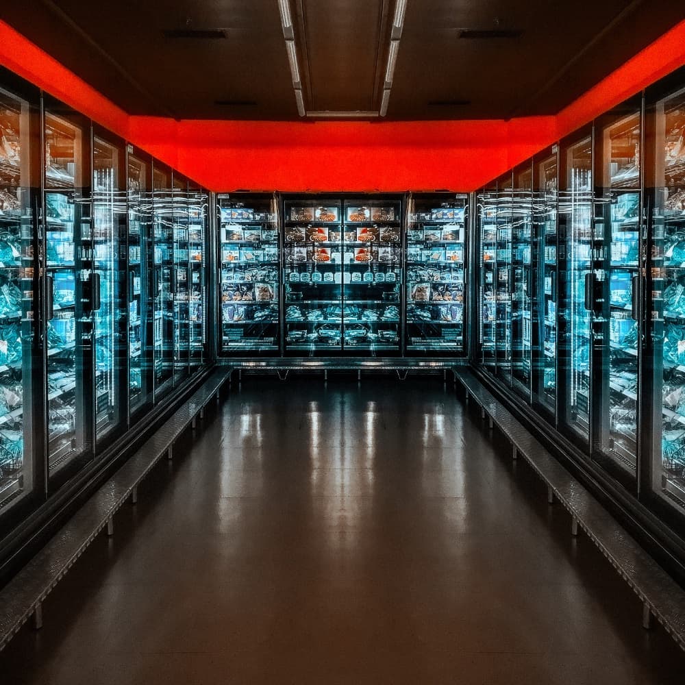 Grocery freezer aisle with glass-door reach-in cases