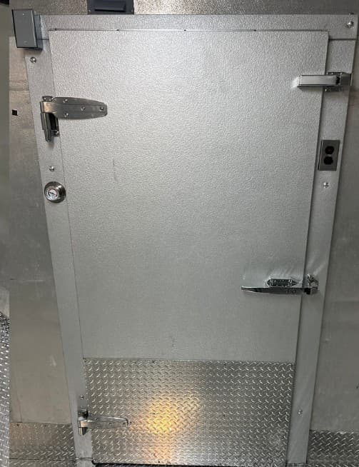 Diamond plate kick plate on a walk-in cooler door