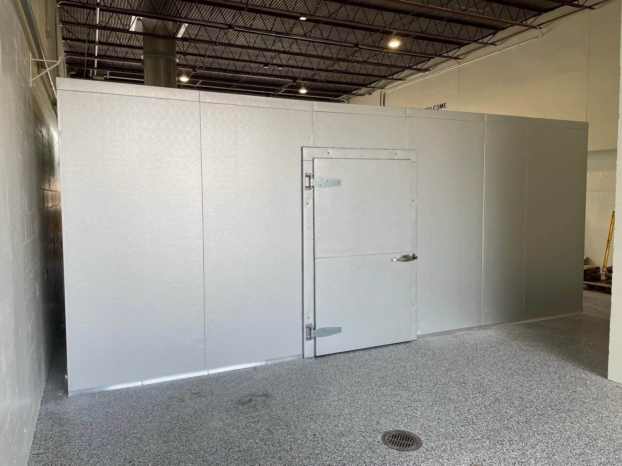 Installed indoor walk-in cooler with door and commercial hardware